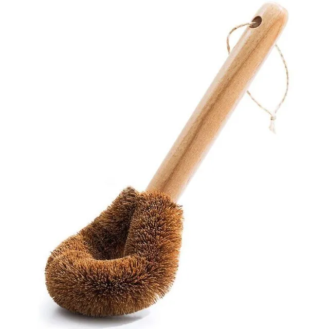 Eco-Friendly Wooden Handle Coconut Fiber Dish Brush – 100% Compostable & Heavy-Duty Scrubber Hand holding wooden handle dish brush cleaning a cast iron skillet